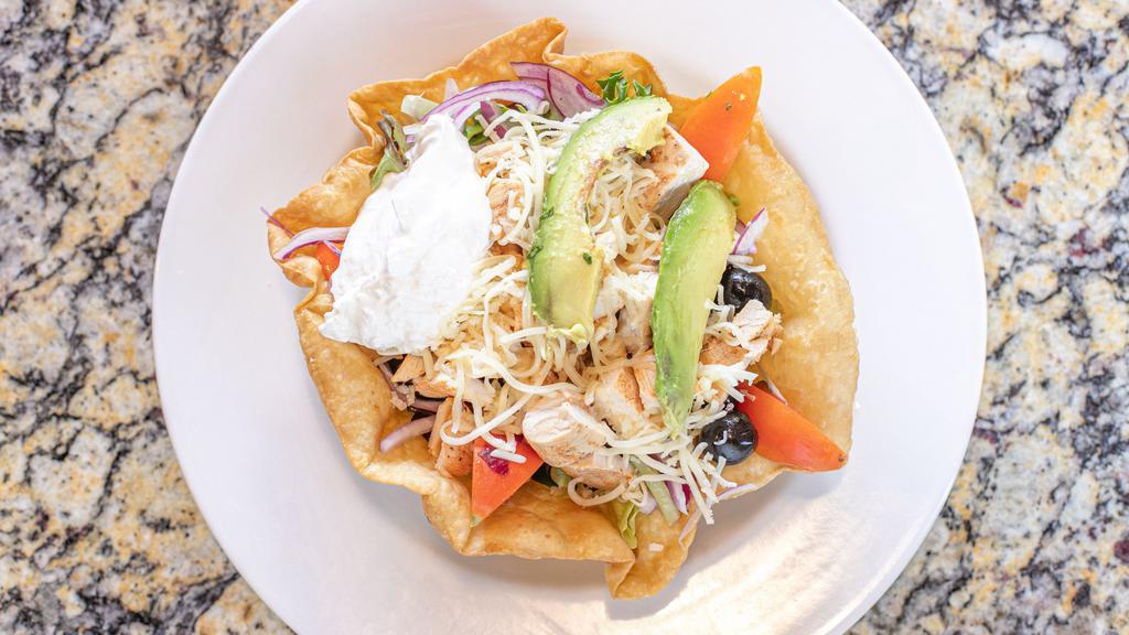 Taco Salad · Crispy taco shell filled with green salad, rice, beans, cheese, sour cream, & your choice of meat (add shrimp for an additional charge).