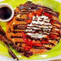 Chocolate Chip Pancakes · Chocolate chips inside. Topped with, strawberries, chocolate sauce, powdered sugar