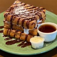 Smores · Graham cracker crusted French toast, marshmallows, chocolate sauce,  and powdered sugar. Whi...