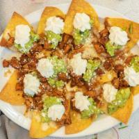 Nachos · Fried corn chips, refried beans, jack cheese, guacamole, sour ream and cotjia cheese.
