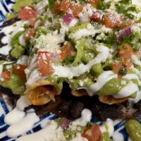 Taquitos · Braised chicken fried taquitos, stewed black beans, avocado salsa, lettuce, pico de gallo, c...