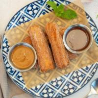 Churros · Fried doughy pastry, cinnamon, sugar, Nutella and dulce de leche.