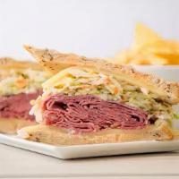 Corned Beef Reuben Sandwich · Grilled corned beef, Swiss cheese, sauerkraut and Russian dressing on grilled rye. Served wi...
