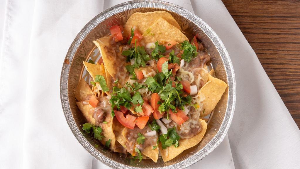 30. Regular nachos · Chips topped with melted cheese, refried beans, and your choice of meat.