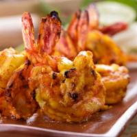 Tandoori Shrimp · Skewered pieces of shrimps marinated in yogurt and spices, baked in a clay oven.