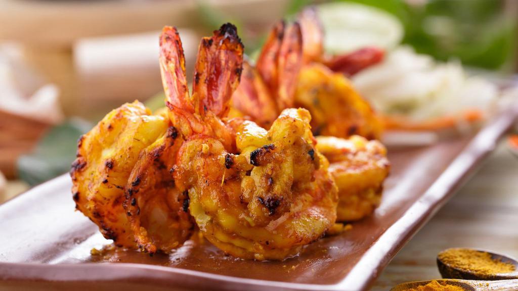Tandoori Shrimp · Skewered pieces of shrimps marinated in yogurt and spices, baked in a clay oven.