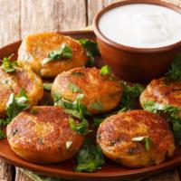 Aloo Tikki · Potato cutlets seasoned with traditional Indian spices and pan-fried.