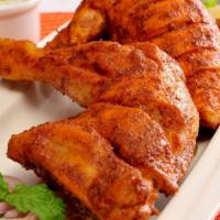 Chicken Tikka Leg · Marinated and spiced chicken leg quarter cooked in a traditional classic tandoor clay oven.