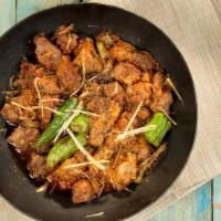 Goat Karahi · A popular street dish of diced goat cooked with spices, herbs and tomatoes in traditional ka...