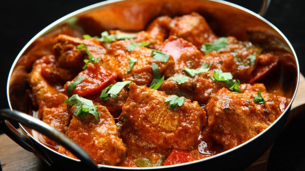 Karahi Chicken · A popular street dish of diced chicken cooked with spices, herbs and tomatoes in traditional karahi (wok).
