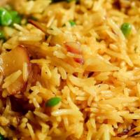 Turmeric Rice · Basmati rice with green peas, sauteed onions and turmeric.