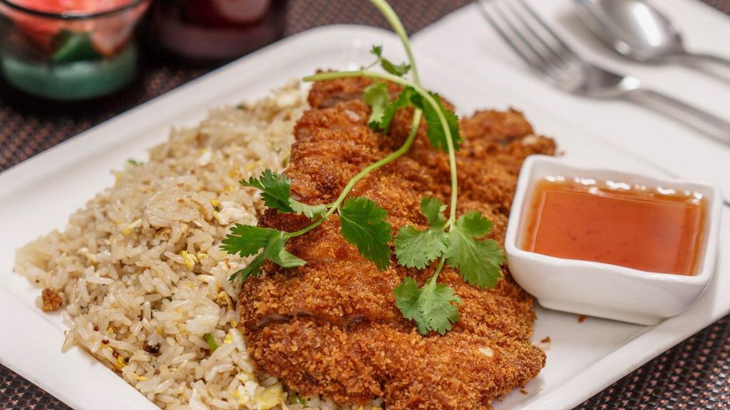 Crispy Chicken Fried Rice · Crispy chicken served with fried rice, eggs, scallions and cilantro served with sweet and sour sauce.