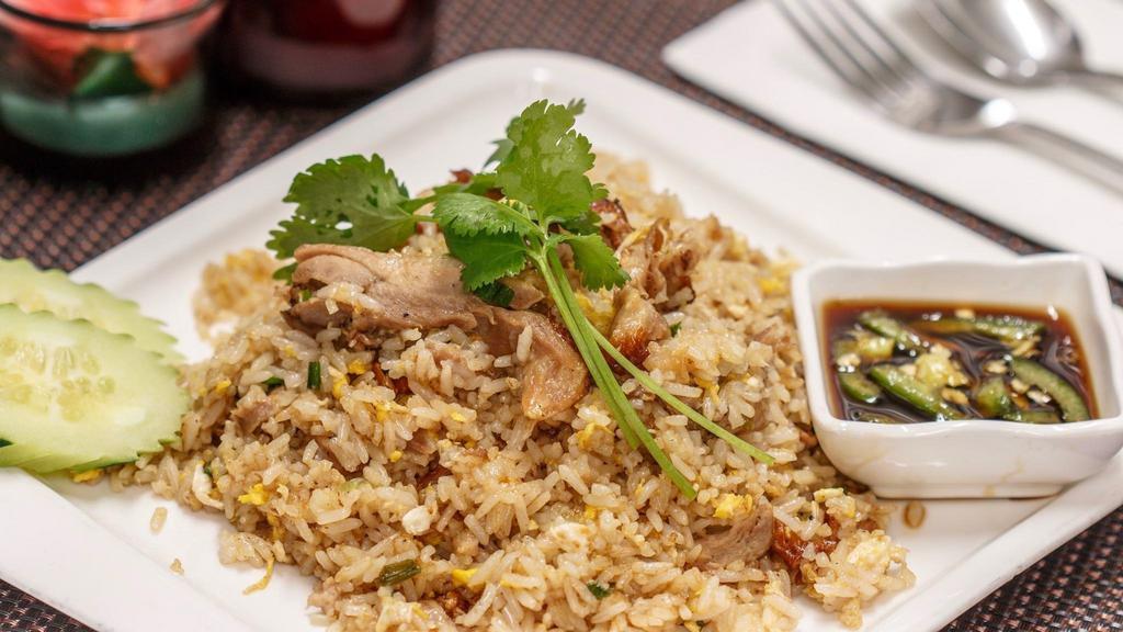 Duck Fried Rice · Thai style fried rice with roasted duck, eggs, scallions and cilantro, served with homemade chili sauce.