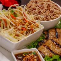 Grilled Pork (Moo Yang) · Thai style BBQ pork with papaya salad or mix salad, sticky rice or steamed rice and served w...