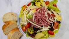 Italian Salad  · Chopped romaine, red peppers, salami, mozzarella, kalamata olives, tomatoes, artichoke hearts, pepperoncinis, Italian dressing, served with sourdough bread. Small salad served with 2 slices of bread, large salad served with 3 slices of bread.