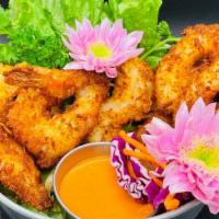 Butterflied Coconut Shrimp · 6 large shrimp butterflied and fried in tempura panko and coconut flakes served with house v...
