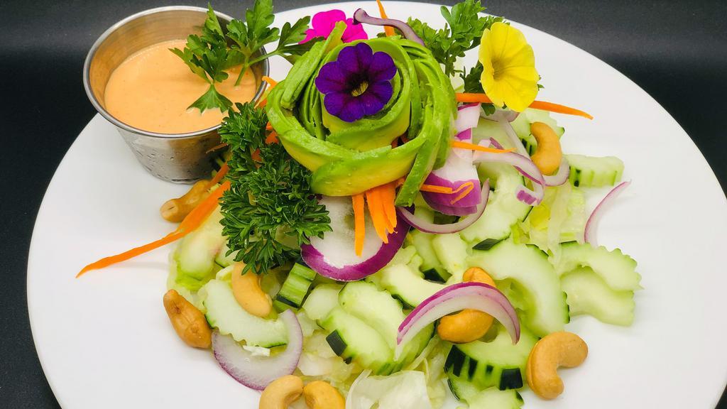 English Cucumber & Avocado Salad · lettuce, red onions, shredded carrots, cucumbers, cashews, avocado, roasted peanuts, & house vinaigrette dressing.