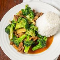 Beef With Broccoli · Stir-fried beef slices in brown sauce with broccoli, decorated with carrot slices, served wi...
