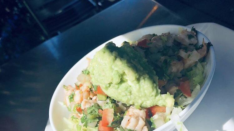 Ceviche · Shrimp, fresh lime juice, avocado slice, tomatoes, onions, cucumber, jalapeños, cilantro, tortilla chips.
