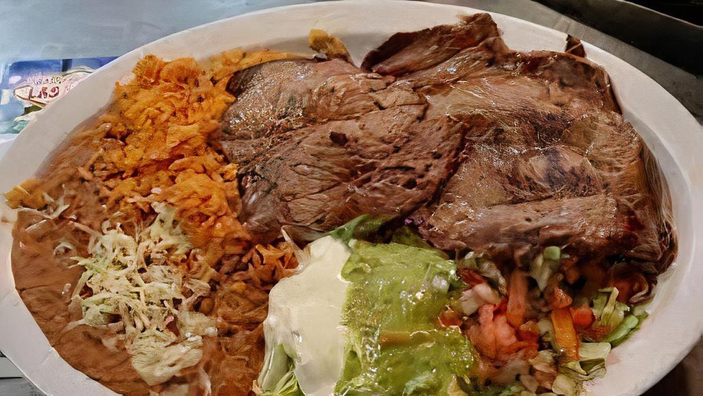 Asada Platter · Steak (certified Angus beef), caramelized onions, salsa ranchera. Served with rice, beans, and side of tortillas.