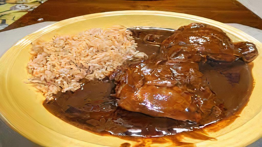 Mole con Pollo · Slow-cooked chicken with mole sauce, sour cream, and Jack cheese. Served with rice and beans.