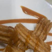 Churros · House made with dulce de leche.