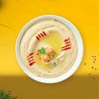 Humming Hummus · A mixture of mashed garbanzo beans, lemon juice and tahini, and garlic served with pita bread.
