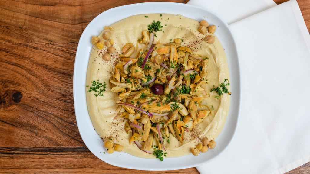 Hummus with Chicken · A mixture of mashed garbanzo beans, lemon juice, and tahini, and garlic served with pita bread topped with chicken.