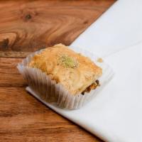 Walnut Baklava · Buttery, flaky phyllo dough soaked in honey and sugar, stuffed and topped with tender walnuts.