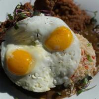 Voodoo Moco · Voodoo fried chicken over hoodoo rice and our famous brown gravy, topped with two sunny side...