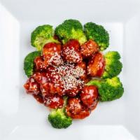 Sesame Chicken · Crispy chunk of chicken with broccoli and sesame seeds in brown sauce.