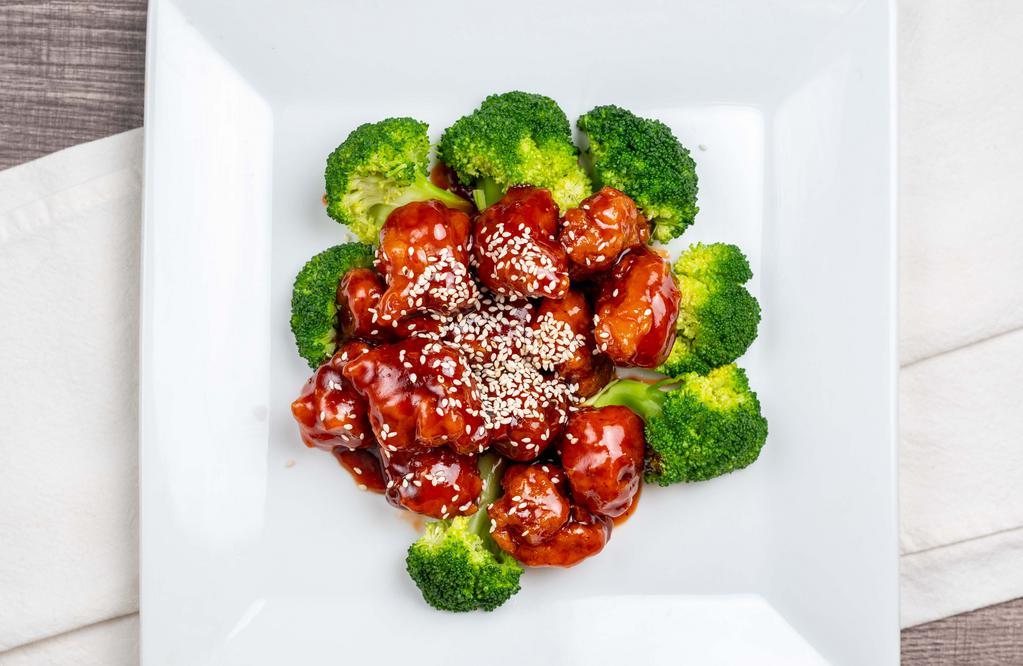 Sesame Chicken · Crispy chunk of chicken with broccoli and sesame seeds in brown sauce.