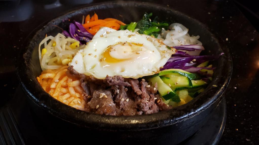 No.64 Dol Sot Bi Bim Bab · Fresh seasoned vegetables, fried egg, beef, and rice in a hot stone pot.