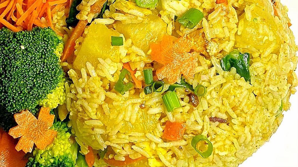 Pineapple Fried Rice · (white or brown rice) Fried rice is stir fried with pineapple , light yellow curry powder, egg and your choice of meat/shrimp/tofu as well as bell peppers and onion.