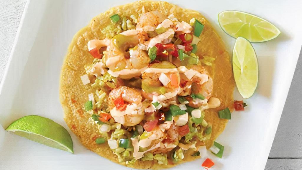 Cajun Shrimp Taco · Shrimp sautéed with cajun seasoning and pico de gallo, cilantro-lime rice, chipotle dressing, avocado-verde salsa, with lime.