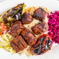7. Beef Shish Plate · Grilled beef skewers, served with rice pilaf, house salad, pickled red cabbage, grilled toma...