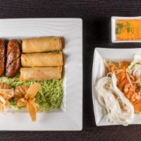 A13. Slk Sampler · Spicy.Thai or Lao style papaya salad, Lao sausage, egg rolls, and money bags.