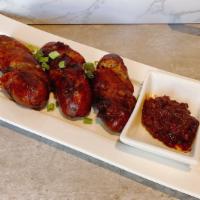 A6. Lao Style Sausages · Spicy. Deep-fried pork sausages with lemon grass and kaffir lime leaf.
