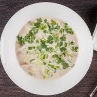 C2. Tom Kha · Sour coconut soup with kaffir lime leaves, ginger, button mushrooms, tomatoes, and choice of...