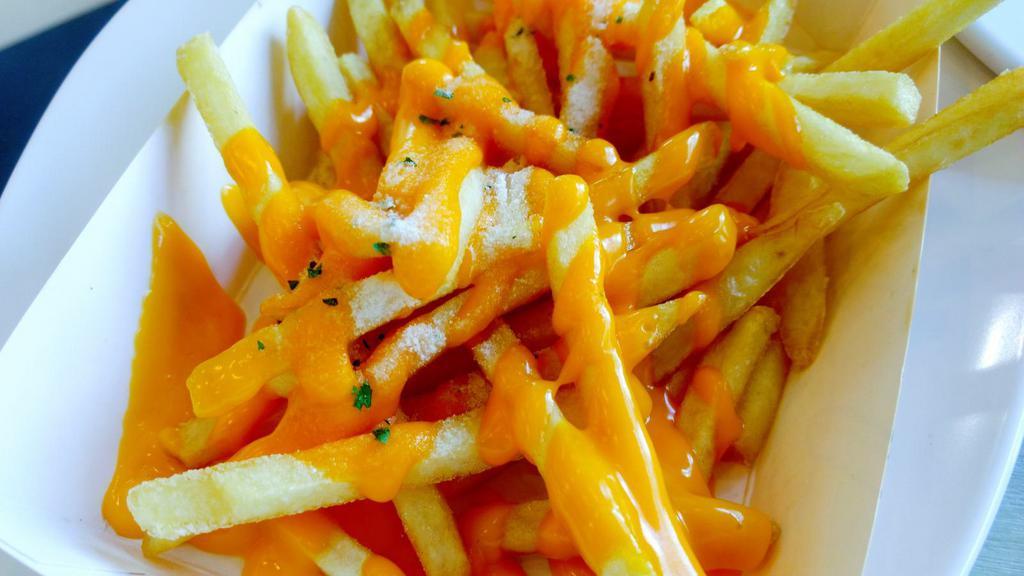 French Fries with Cheese · Crispy golden fresh made French fries smothered in creamy cheese.