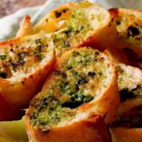 Pesto Garlic Bread with Cheese · Fresh baked garlic bread topped with melted mozzarella cheese and house made pesto sauce.