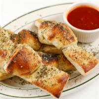 Garlic Knots (4) · KNOT YOUR ORDINARY KNOT.  4 very large knots from our pizza dough smother in garlic, olive o...