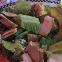 Chicken Cobb Salad · Charboiled chicken breast over fresh greens, bacon, crumbled blue cheese, avocado, hard boil...