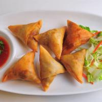 83.	Samosa (5 pcs) · Crispy pastry filled potatoes, onions & spices w/ house sauce