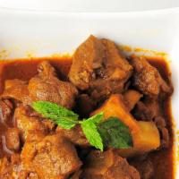 45. Shwe Myanmar Style Lamb Curry · Slow braised lamb with onions, ginger, garlic, spices, and potatoes.