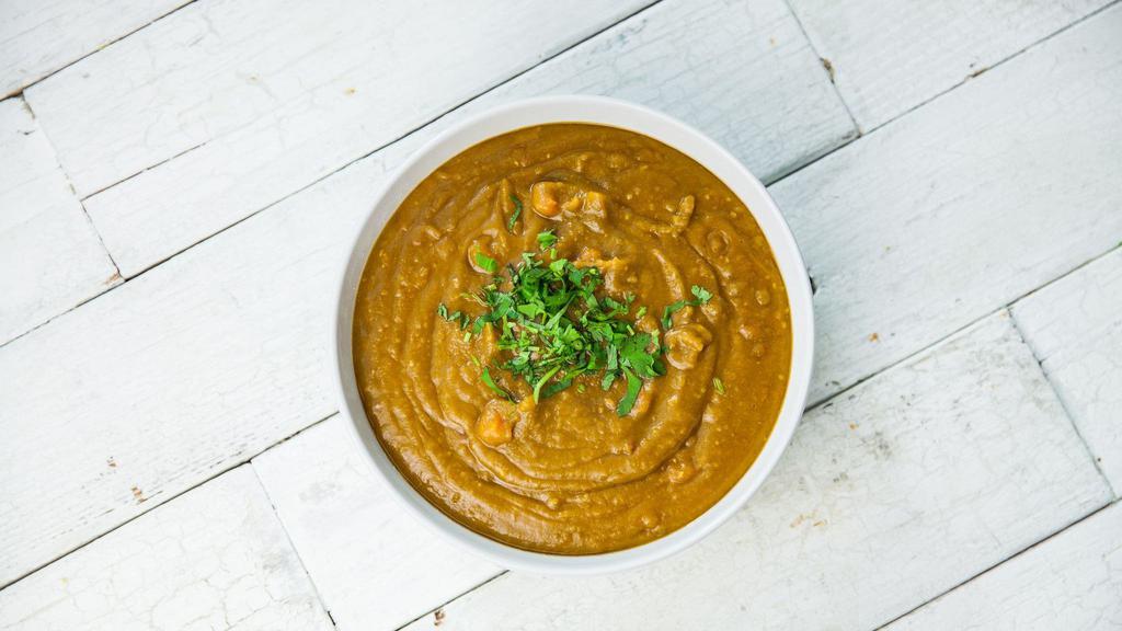 Organic Smoky Spilt Pea · A hearty vegetarian split pea soup with chunks of carrots and tomatoes and a hint of smoke from chipotle chiles. Garnished with cilantro. Vegetarian, lowfat, dairy free, gluten free.