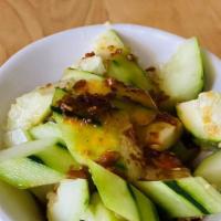 Cucumber Salad 拍黃瓜 · Fresh cut cucumbers mixed with minced garlic and salt served in hot chili oil sauce.