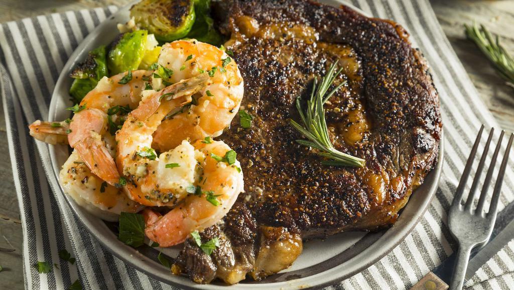 Ribeye Steak & Shrimp · Juicy Ribeye Steak rich in flavor alongside Flavorful Shrimp. Comes with Steamed Sautéed Vegetables and your choice of Creamy Mashed Potatoes with Gravy or Roasted Yams.