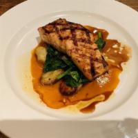 Grilled Salmon · Roasted potatoes and sauteed spinach, piperade sauce, balsamic reduction.