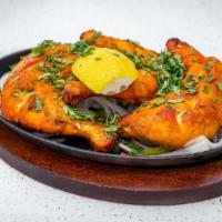 Tandoori Chicken · Chicken breast and leg marinated in with yogurt, garlic, ginger, lemon, and tandoori spices.